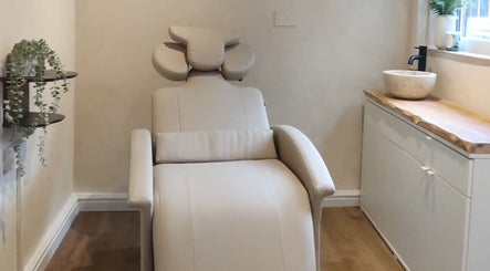 Relaxing treatment room at Athena by Sophia Olivia, Alderley Edge, England, GB featuring a plush reclining chair.