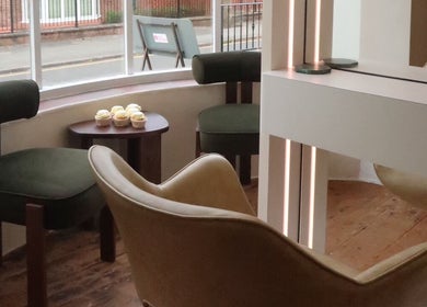 Cozy seating area at Athena by Sophia Olivia in Alderley Edge, England, GB, featuring elegant chairs and cupcakes.