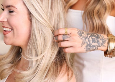 Stylist at Athena by Sophia Olivia in Alderley Edge, England styling blonde hair with care.