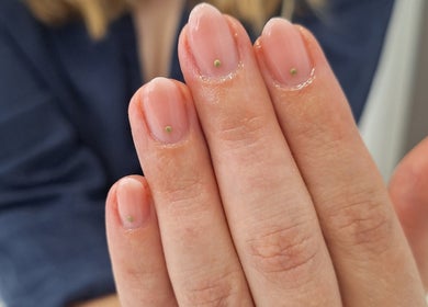 Sophisticated nail art featuring tiny green dots at Nails Quoture, Glasgow, Scotland, GB.