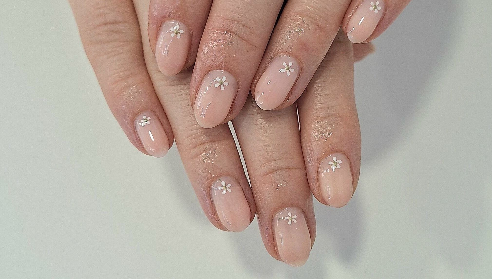 Delicate floral nail art at Nails Quoture, Glasgow, Scotland, GB, showcasing expert manicure skills.