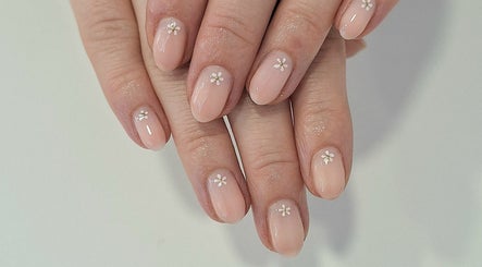 Delicate floral nail art at Nails Quoture, Glasgow, Scotland, GB, showcasing expert manicure skills.