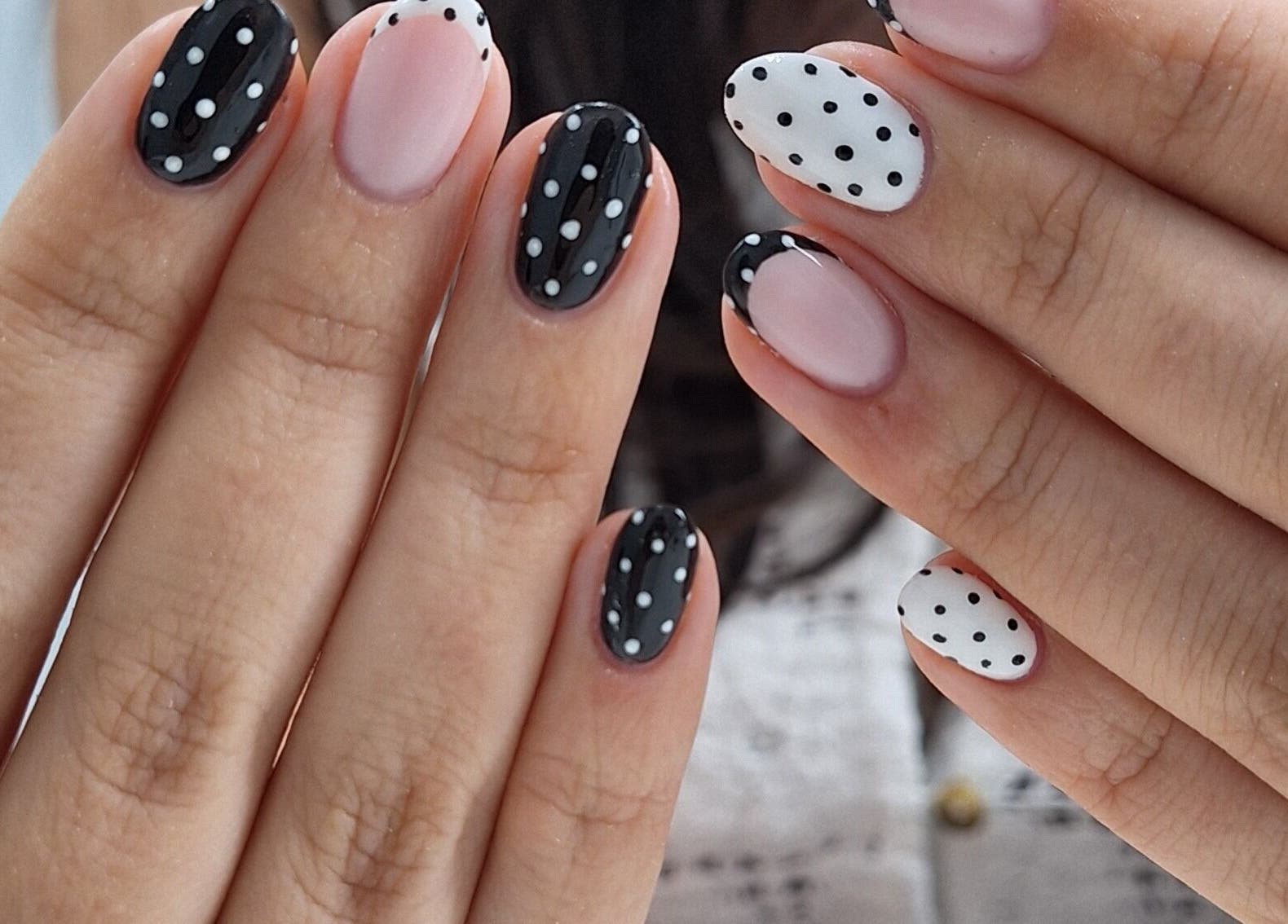 Chic polka dot nail art at Nails Quoture, Glasgow, Scotland, GB. Elegant black and white manicure design.