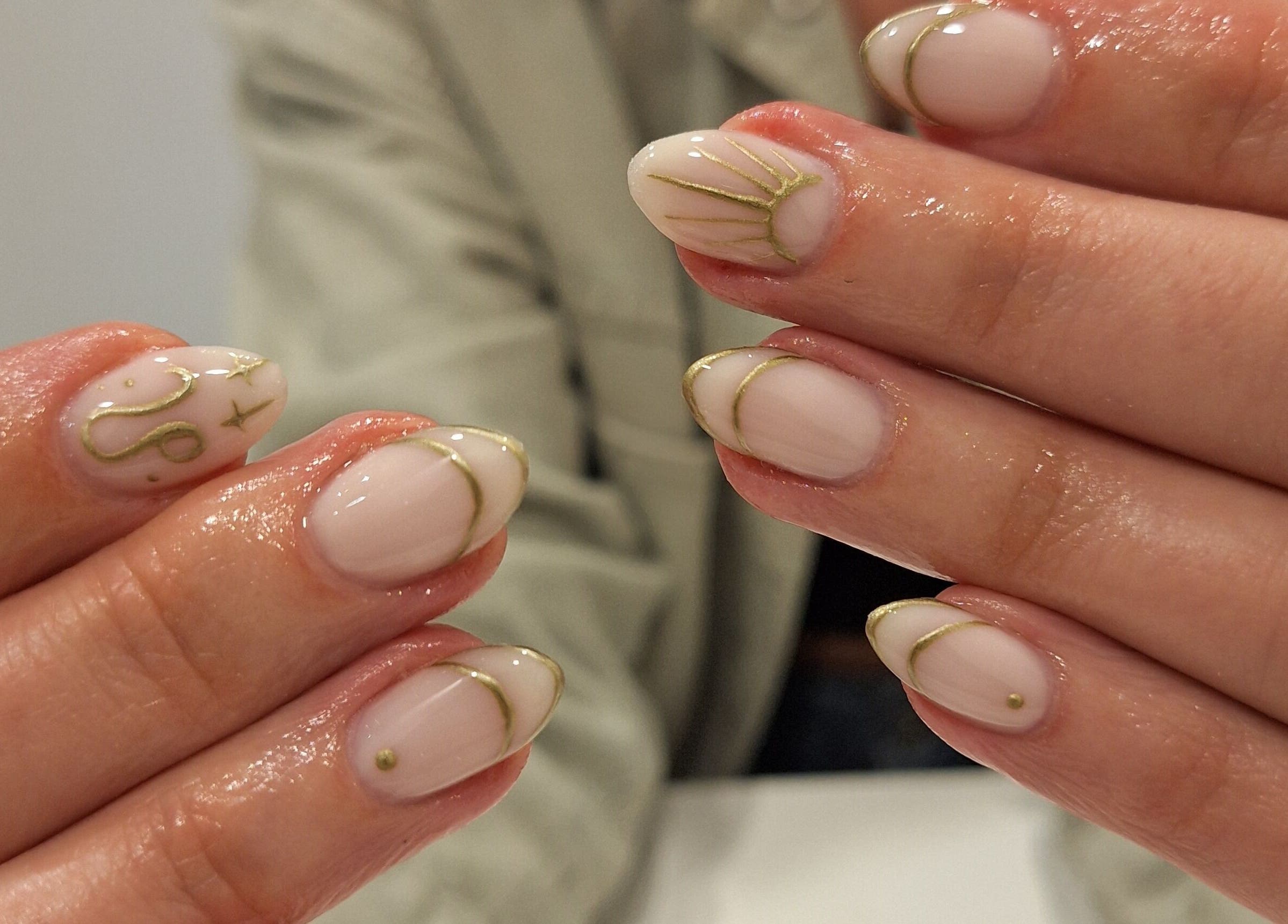 Chic nail art with gold accents at Nails Quoture, Glasgow, Scotland, GB.