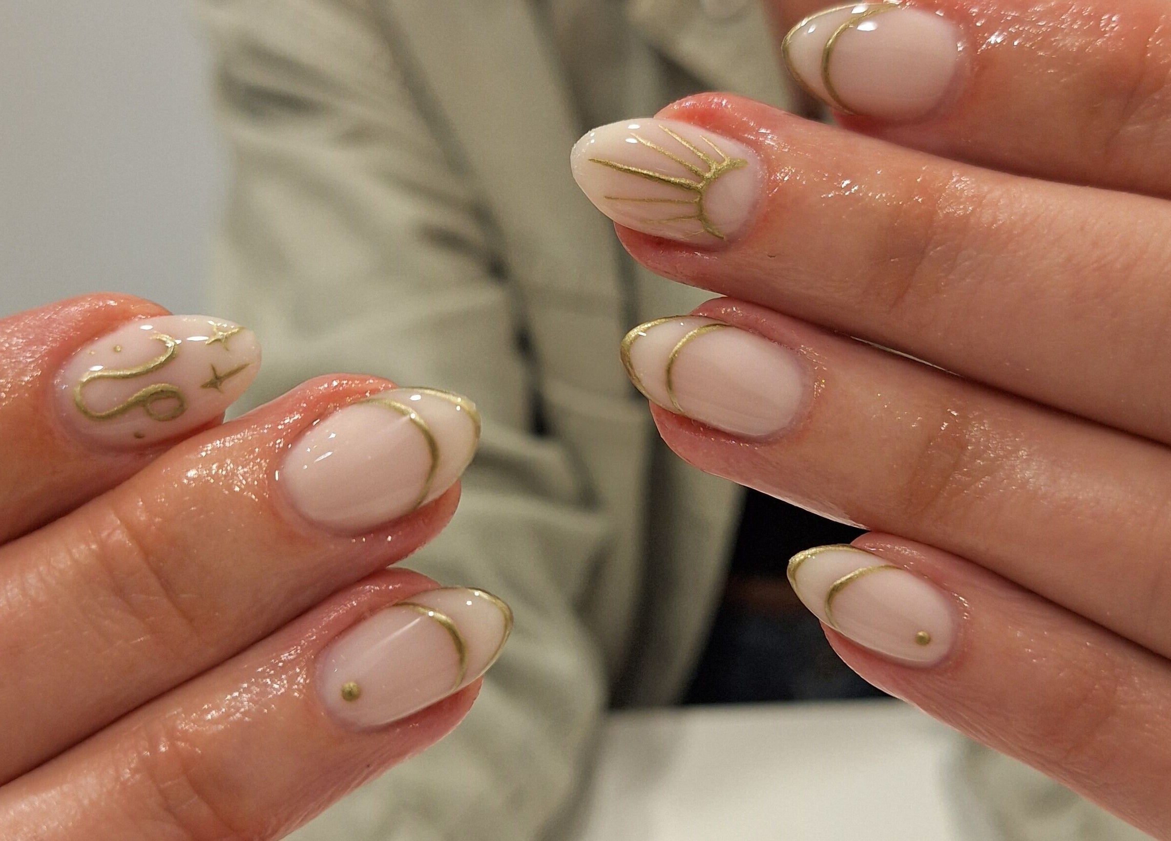 Chic nail art with gold accents at Nails Quoture, Glasgow, Scotland, GB.
