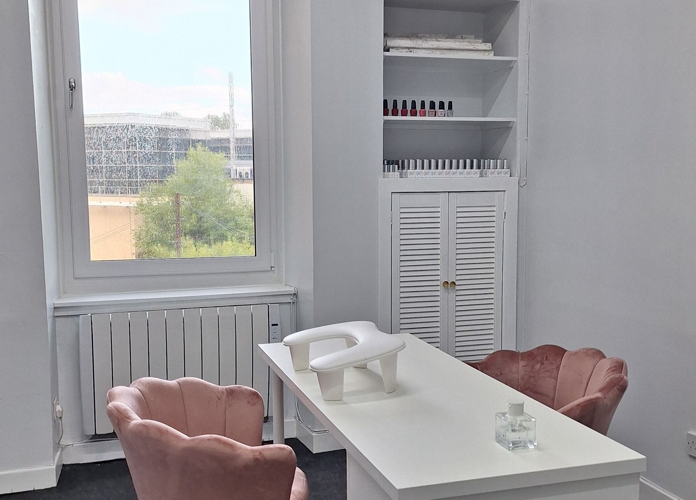 Chic nail salon corner at Nails Quoture in Glasgow, Scotland, GB, with elegant pink chairs and a bright window view.