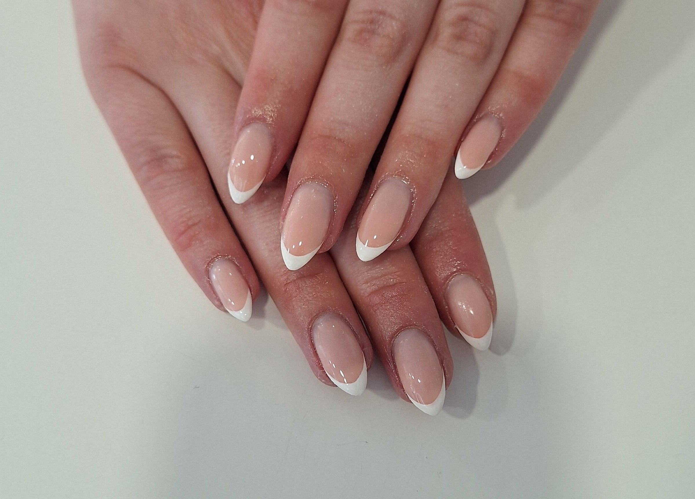 Stylish French manicure at Nails Quoture in Glasgow, Scotland, GB showcasing elegant white tips on natural nails.