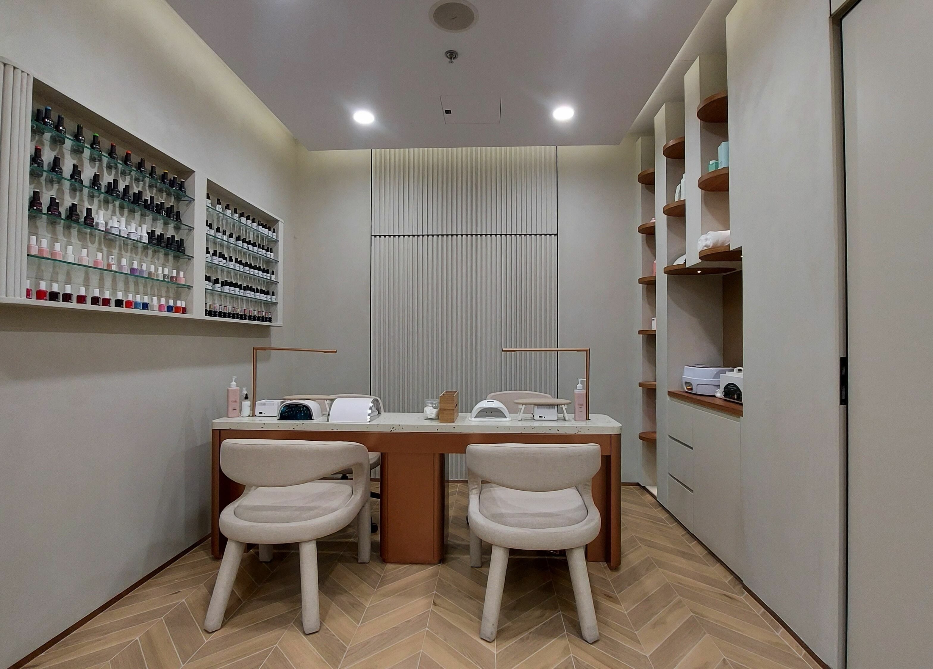 Cabello Lounge Femme Ladies Salon nail service area in Dubai, AE featuring polished decor and organized nail polishes.