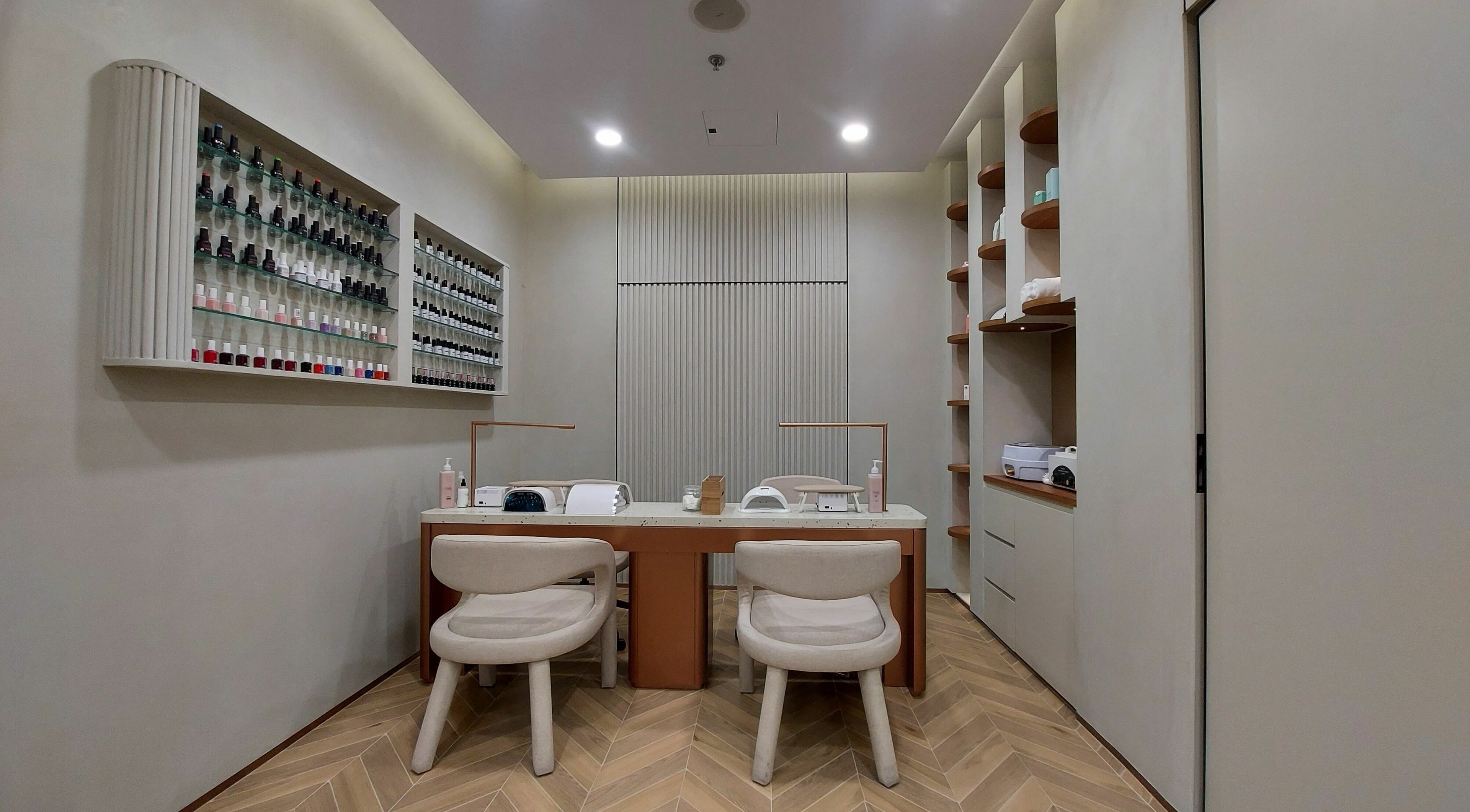 Cabello Lounge Femme Ladies Salon nail service area in Dubai, AE featuring polished decor and organized nail polishes.