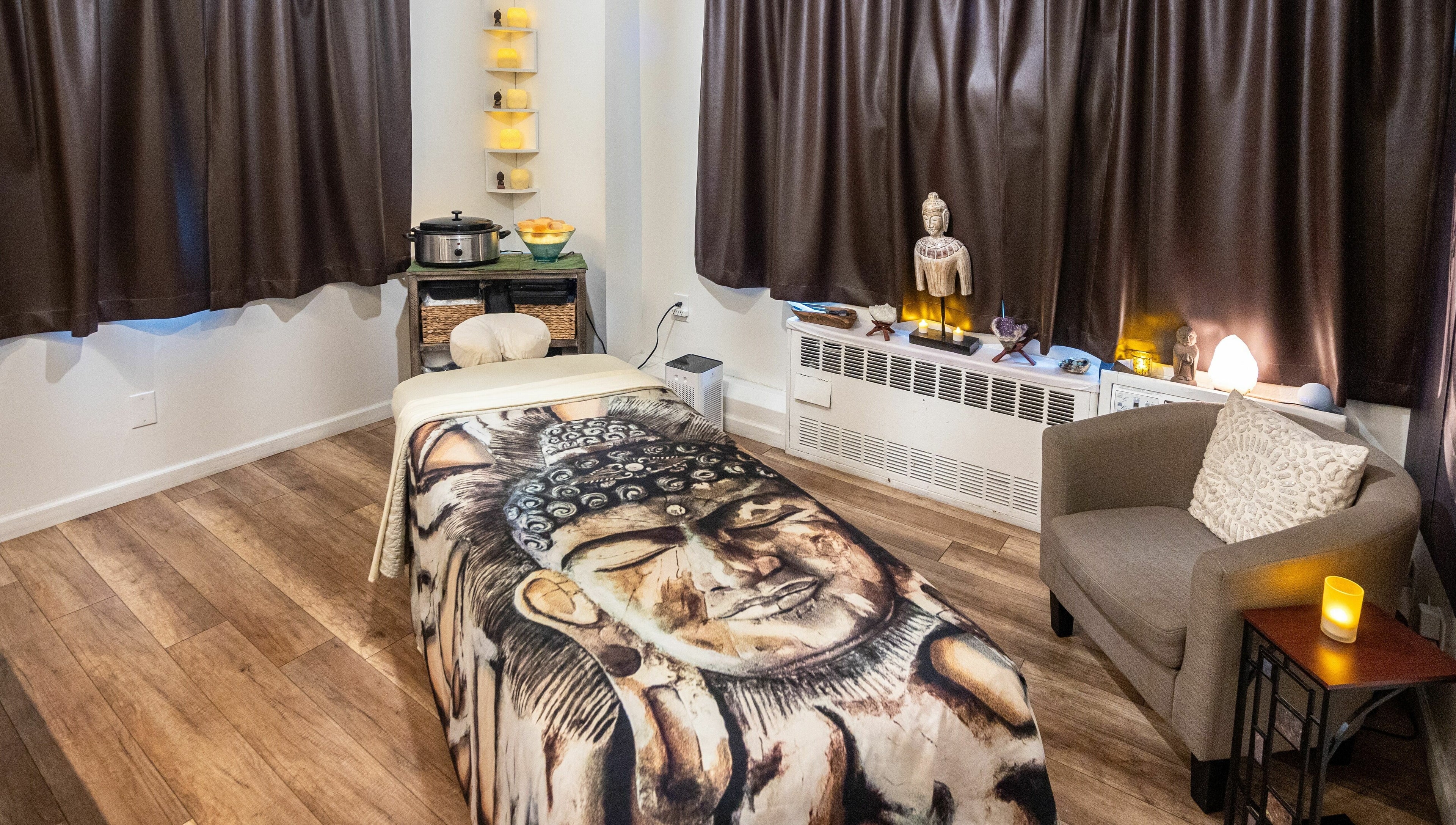 Relaxing massage room at The MJ Treatment Spa and Wellness, New York, New York, US, featuring serene decor.