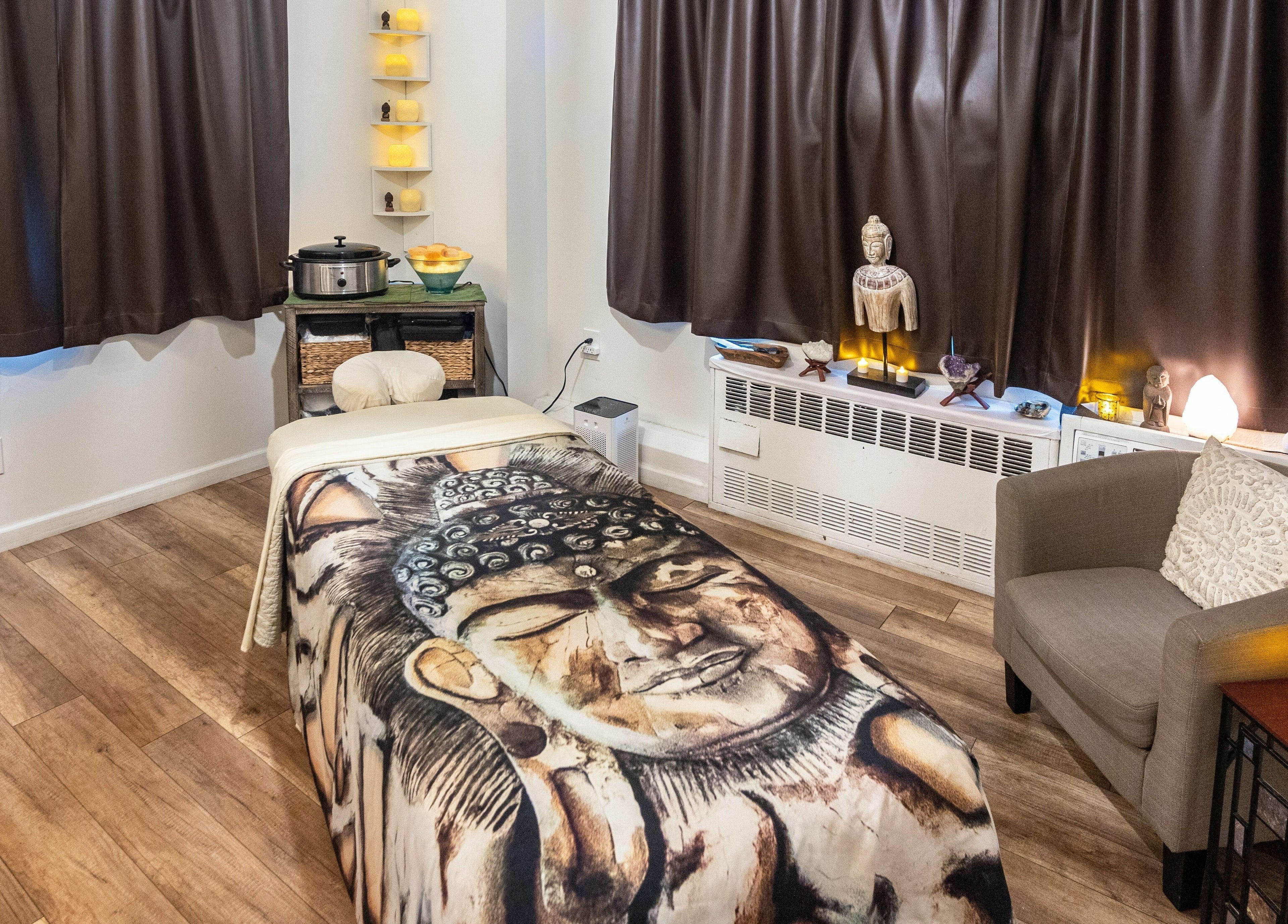 Relaxing massage room at The MJ Treatment Spa and Wellness, New York, New York, US, featuring serene decor.