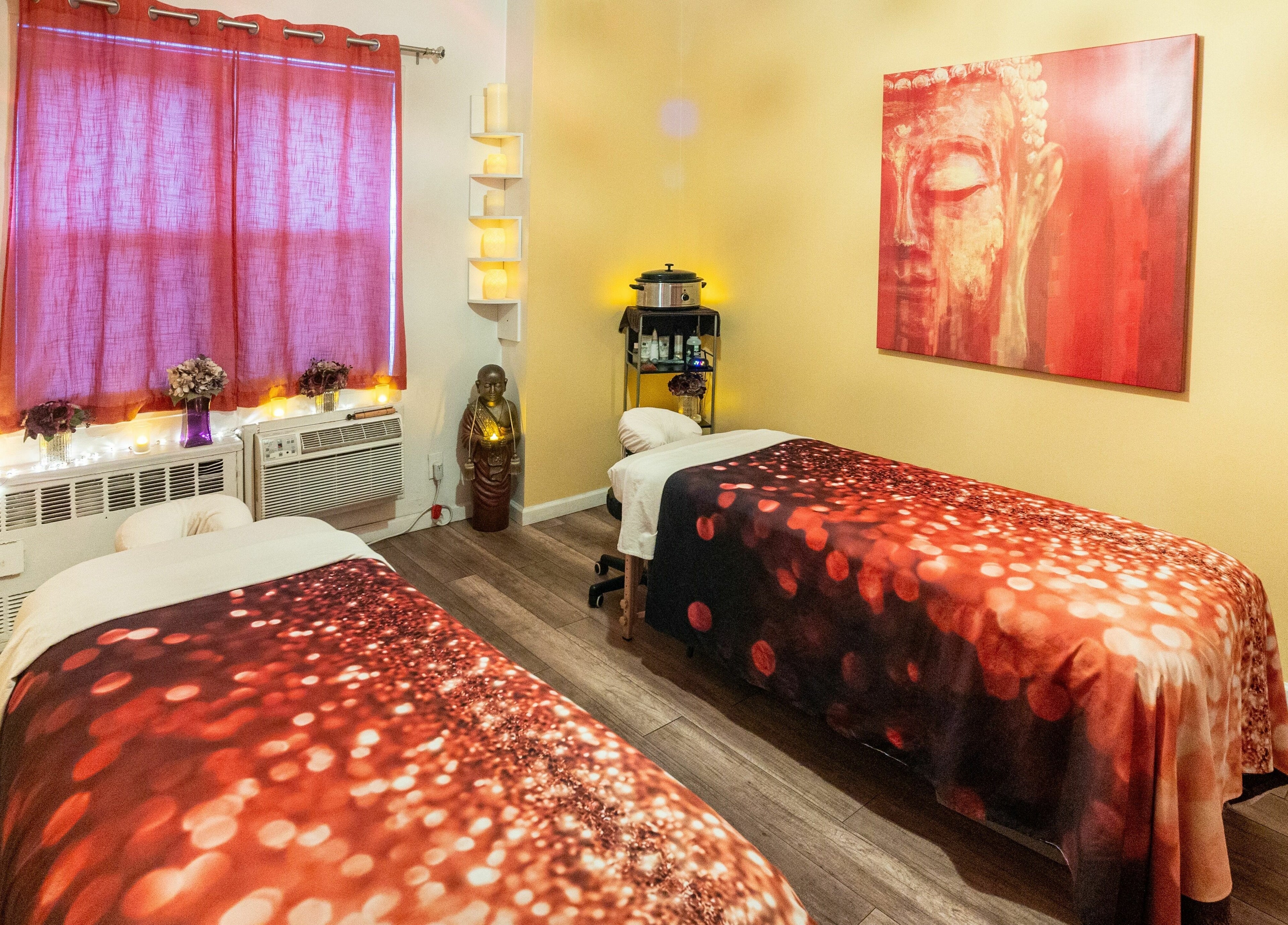 Relaxing massage room at The MJ Treatment Spa and Wellness, New York, New York, US with warm decor.