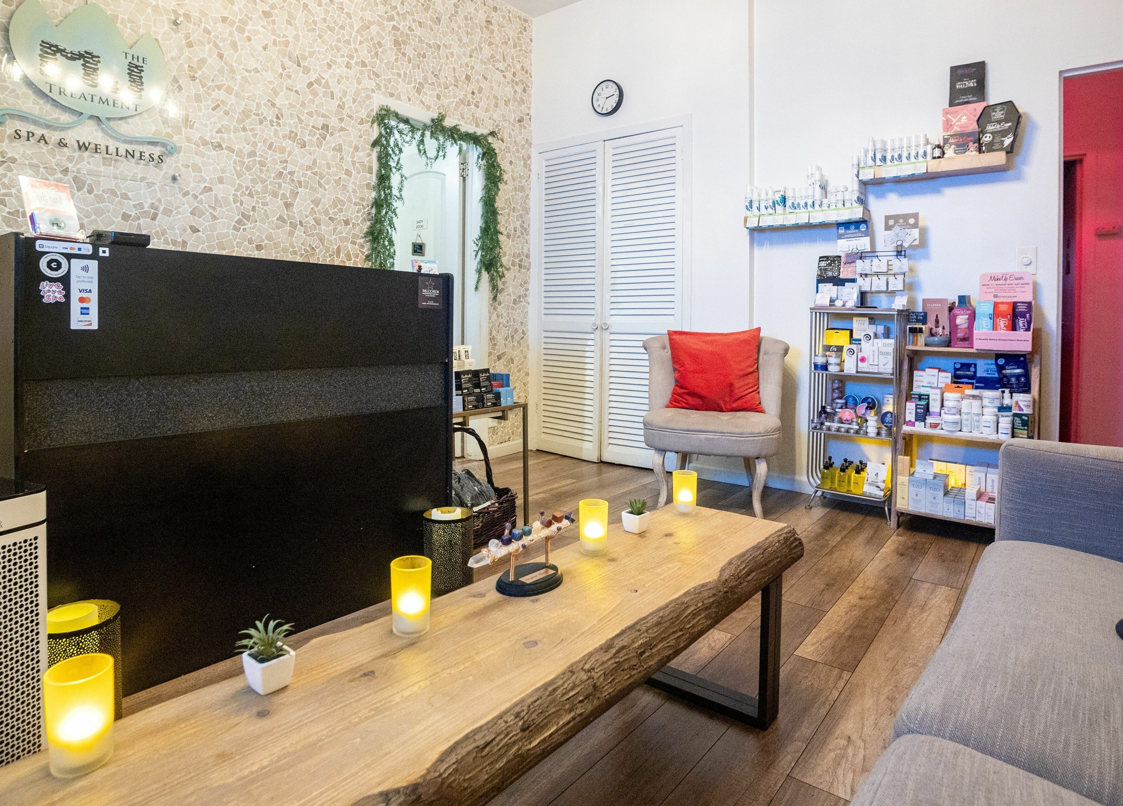 Relaxing reception at The MJ Treatment Spa and Wellness, New York, New York, US with candles and products.