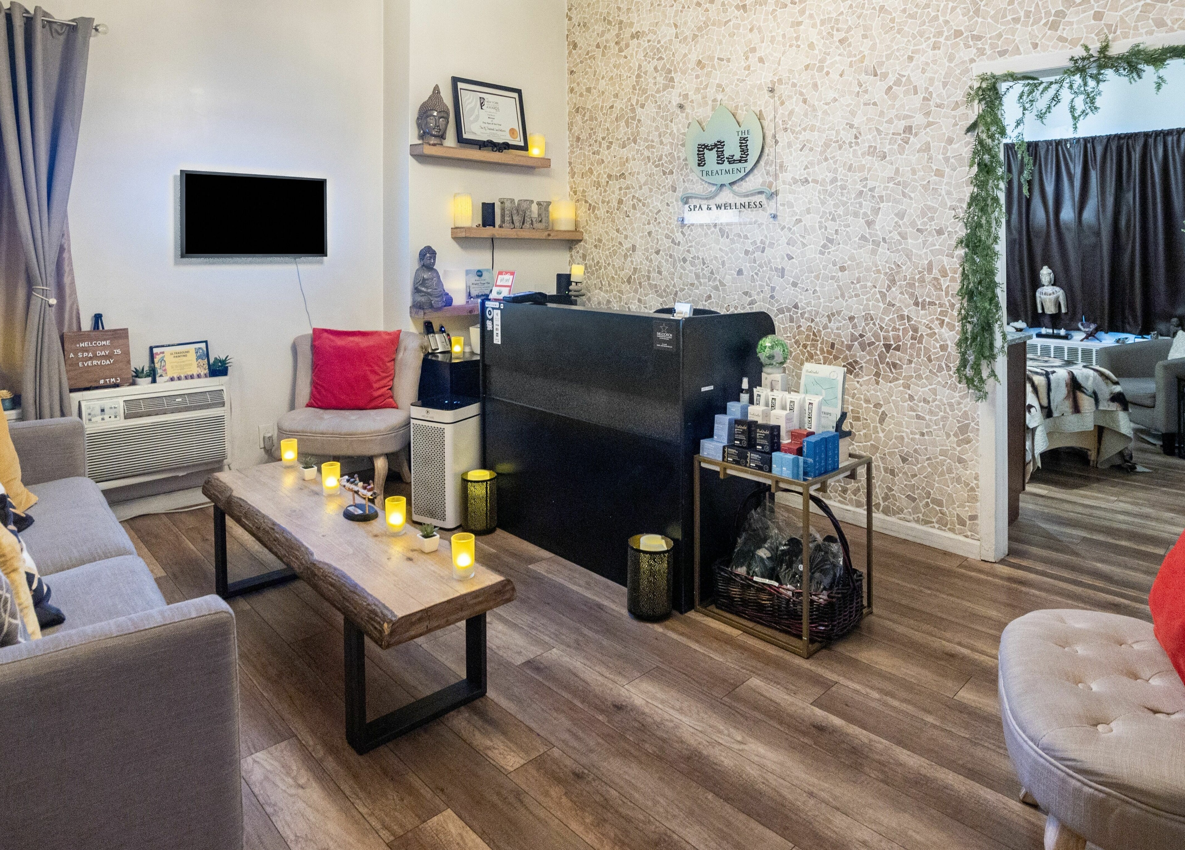 Welcoming reception area at The MJ Treatment Spa and Wellness, New York, New York, US, with warm decor.
