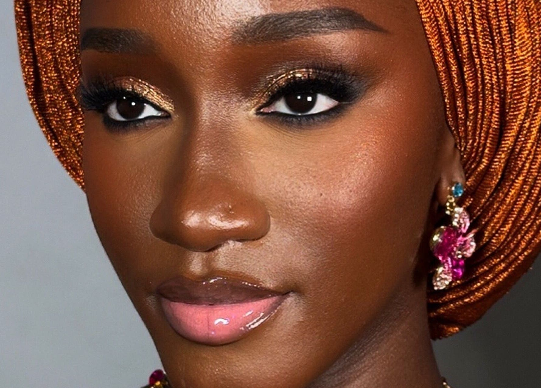 Elegant makeup look at Flawless Face by Jane, Lagos, Lagos, NG showcasing shimmering eyes and glossy lips.