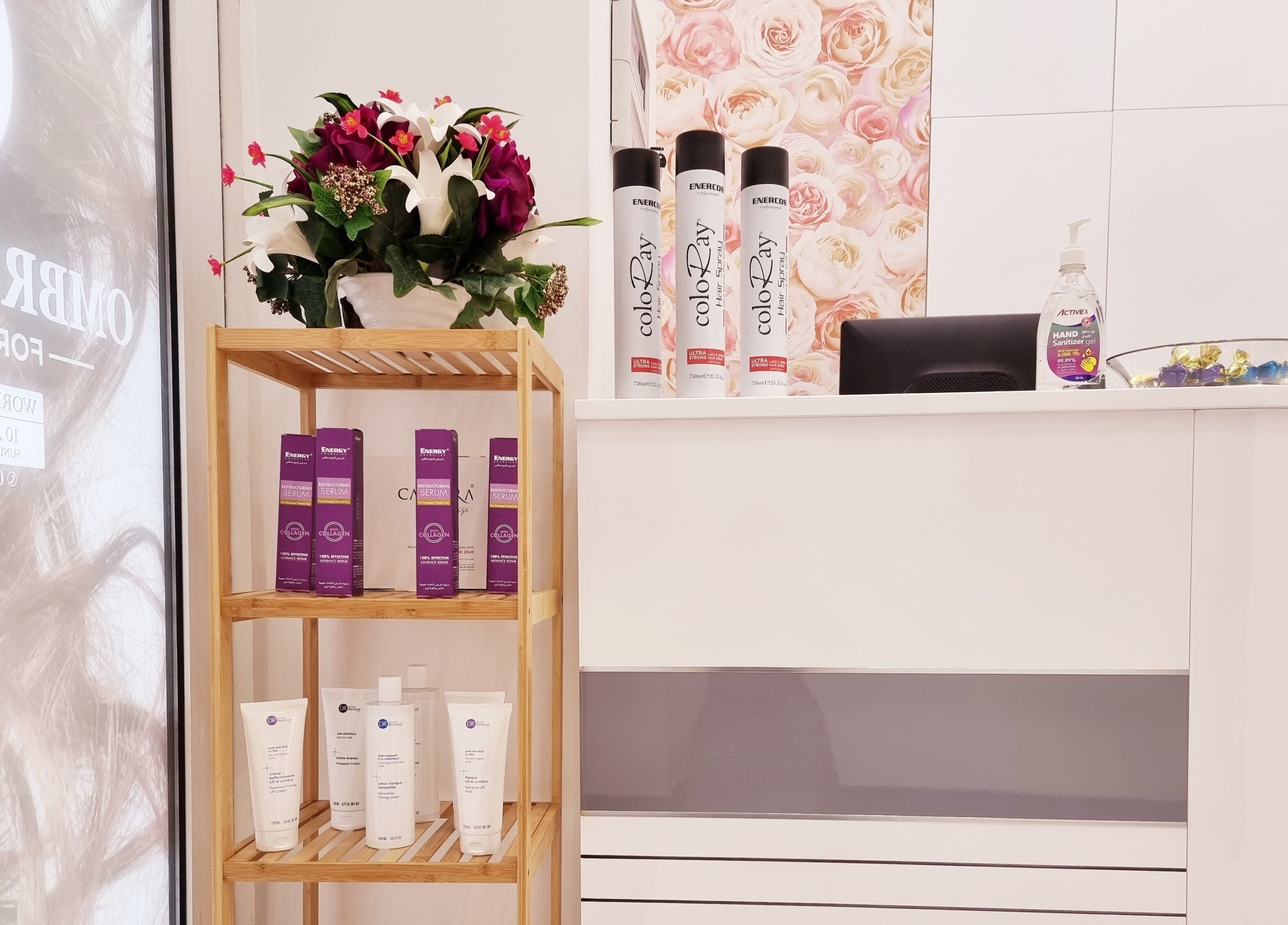 Stylish reception area with floral decor and products at Ombre Salon for Ladies LLC, Dubai, AE.