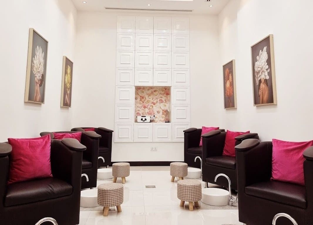 Modern pedicure area at Ombre Salon for Ladies Branch in Dubai, Dubai, AE, featuring plush chairs and floral decor.