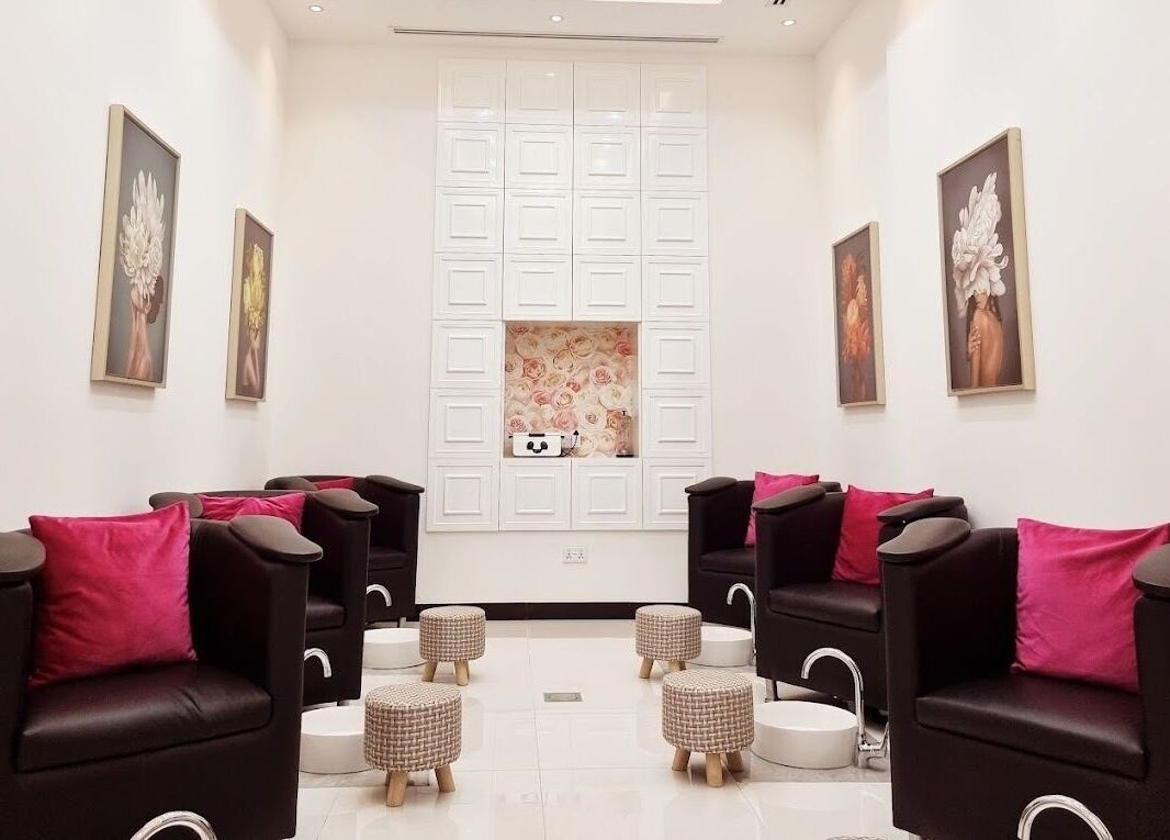 Modern pedicure area at Ombre Salon for Ladies Branch in Dubai, Dubai, AE, featuring plush chairs and floral decor.