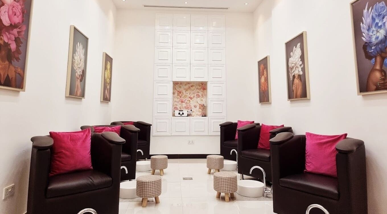 Modern pedicure area at Ombre Salon for Ladies Branch in Dubai, Dubai, AE, featuring plush chairs and floral decor.