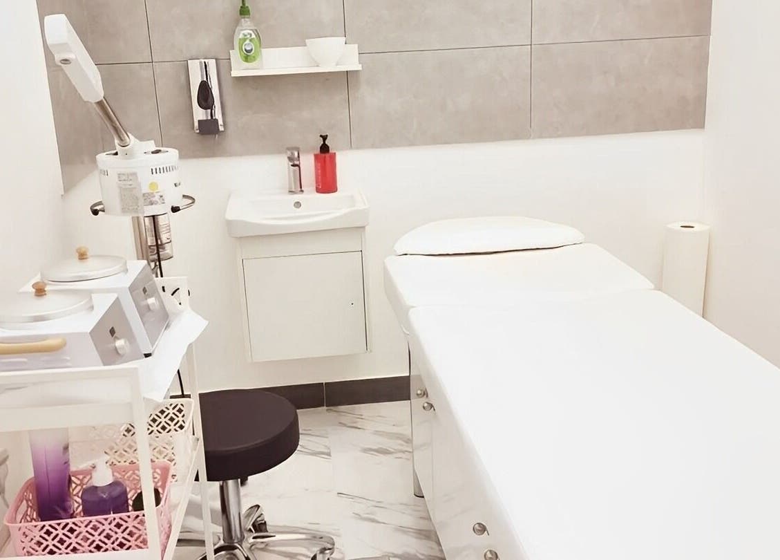 Tranquil spa room at Ombre Salon for Ladies Branch, Dubai, Dubai, AE, featuring a treatment bed and equipment.