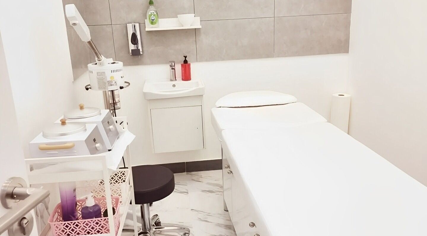 Tranquil spa room at Ombre Salon for Ladies Branch, Dubai, Dubai, AE, featuring a treatment bed and equipment.