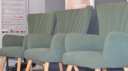 Stylish green chairs at Uptown Beauty in Hillcrest, Kwazulu-natal, ZA enhance the welcoming ambiance.