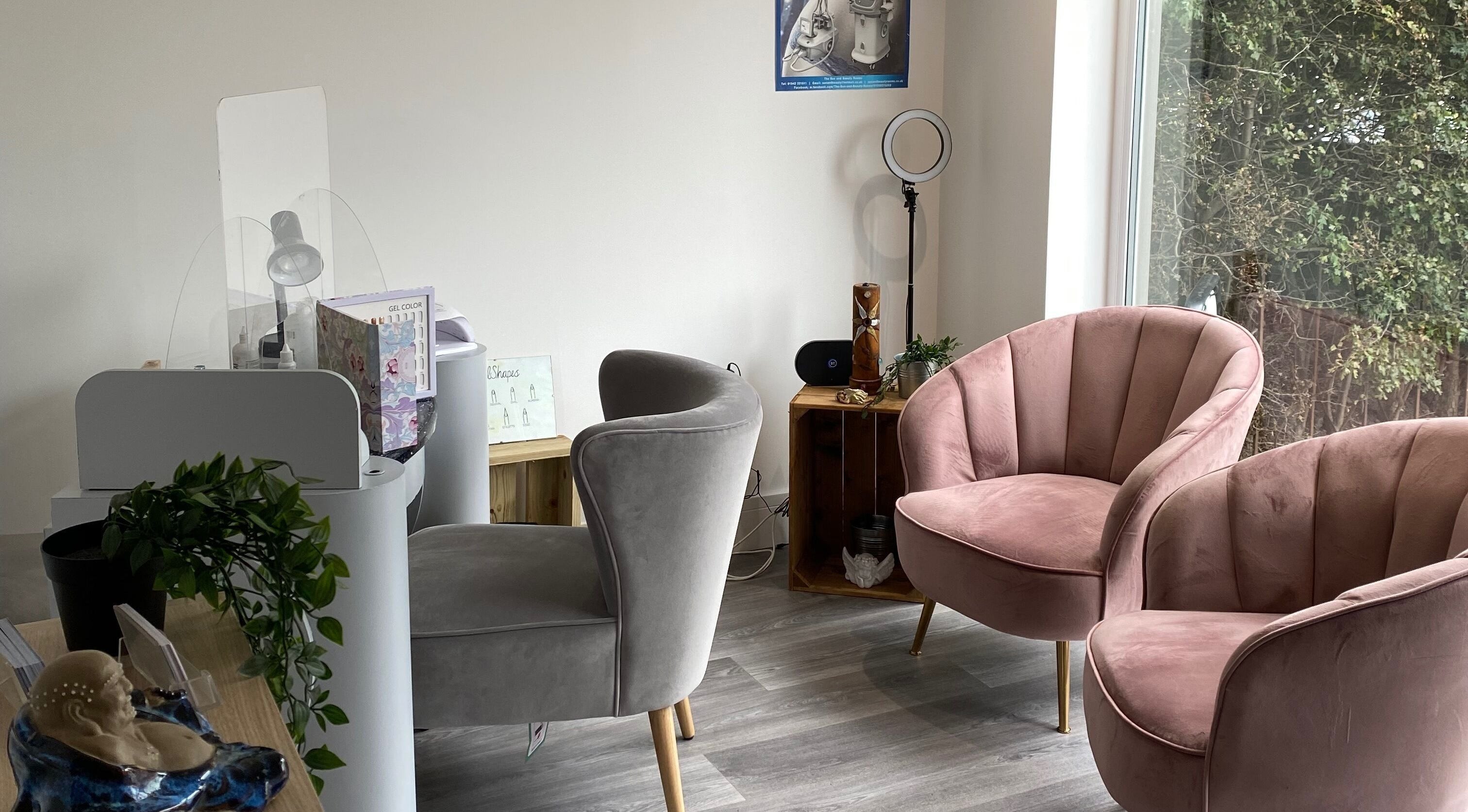 Inviting seating area at The Sun and Beauty Rooms, Wigan, England, GB with plush chairs and nail station.