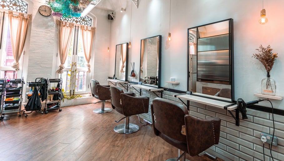 Stylish salon chairs and mirrors at Ha Lu Hair Design in Singapore, Singapore, SG with elegant decor.