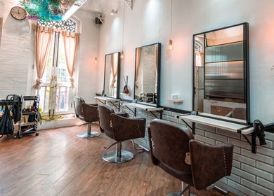 Stylish salon chairs and mirrors at Ha Lu Hair Design in Singapore, Singapore, SG with elegant decor.