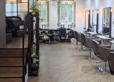 Elegant interior of Ha Lu Hair Design, Singapore, SG featuring sleek salon chairs and mirrors.
