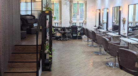 Elegant interior of Ha Lu Hair Design, Singapore, SG featuring sleek salon chairs and mirrors.