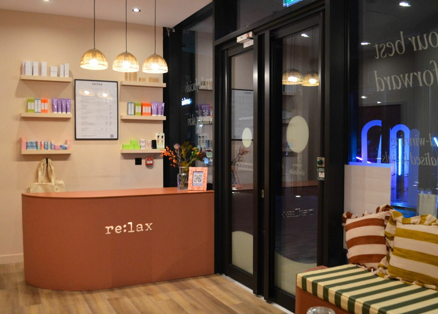 Welcoming reception area at re:lax Borough Yards, London, England, GB, with cozy seating and products on display.