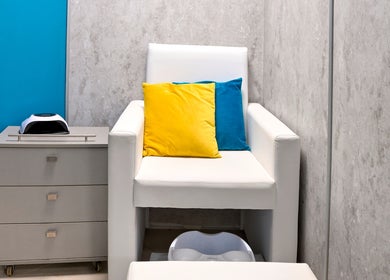 Cozy white chair with vibrant cushions at Varna Beauty Studio, Варна, Варна, BG.