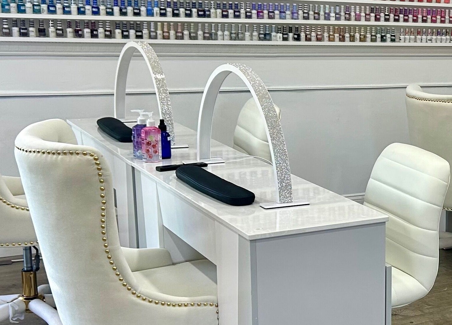 Luxurious nail stations at Petite Nails and Spa in Chelmsford, Massachusetts, US showcasing elegant white decor.