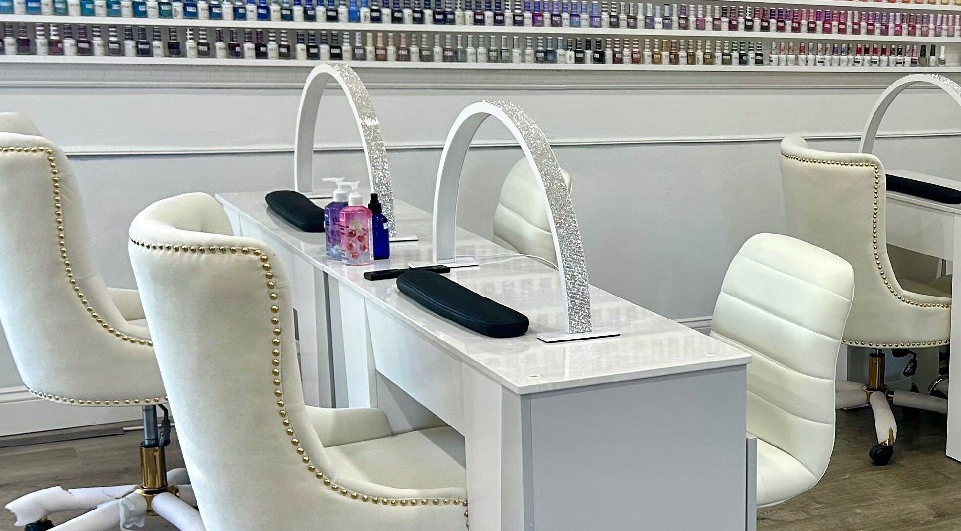 Luxurious nail stations at Petite Nails and Spa in Chelmsford, Massachusetts, US showcasing elegant white decor.