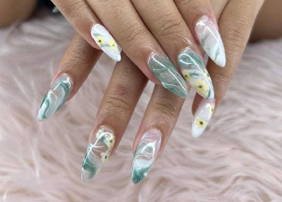 Elegant floral nail art at Petite Nails and Spa in Chelmsford, Massachusetts, US on a cozy pink background.