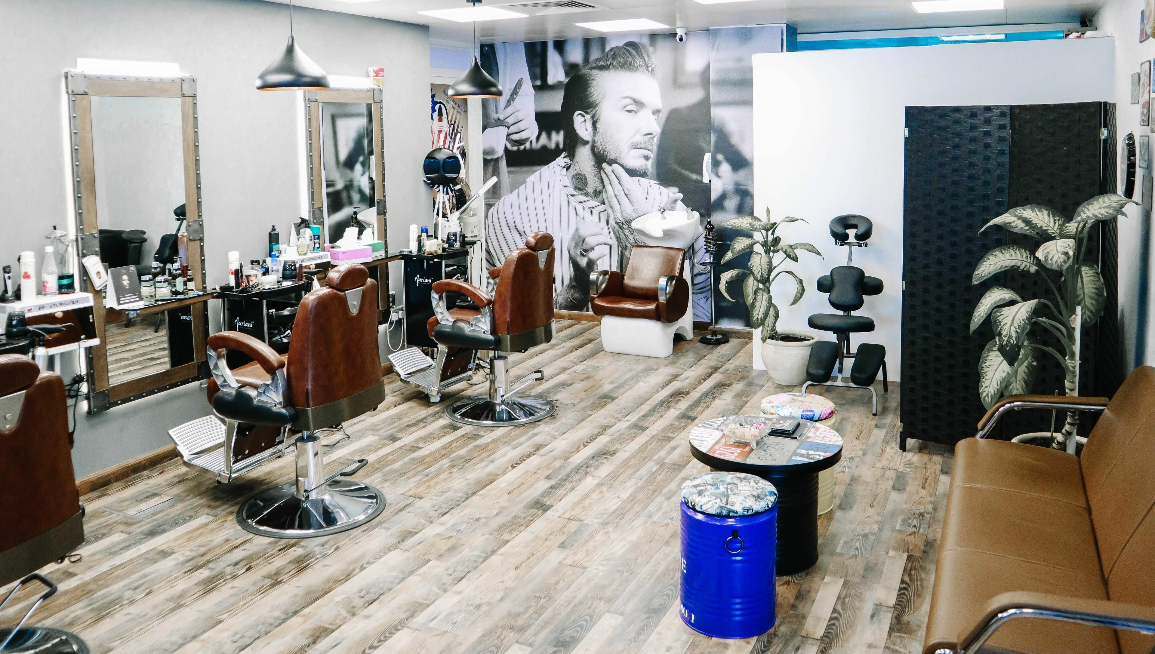Interior of Sfizio Gent's Salon, Al Khail Branch, showcasing stylish barber chairs in Dubai, AE.
