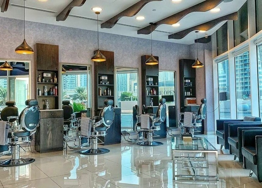 Sfizio Gent's Salon, Al Khail Branch's sleek interior in Dubai, AE, featuring stylish barber chairs and decor.
