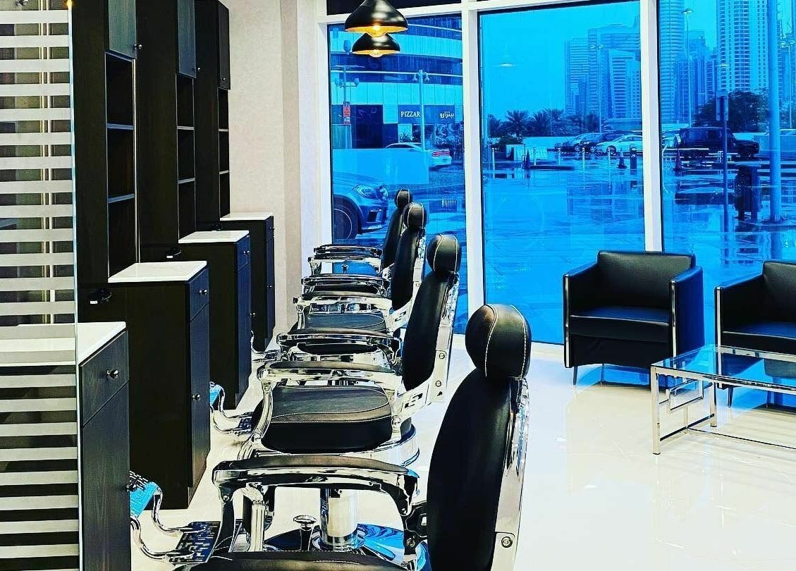Luxurious interior of Sfizio Gent's Salon, Al Khail Branch, Dubai, AE featuring modern barber chairs and city view.