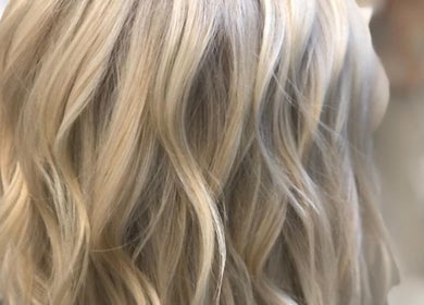 Blonde wavy hairstyle at Elevate Salon Llc in Alpena, Michigan, US showcasing expert styling.