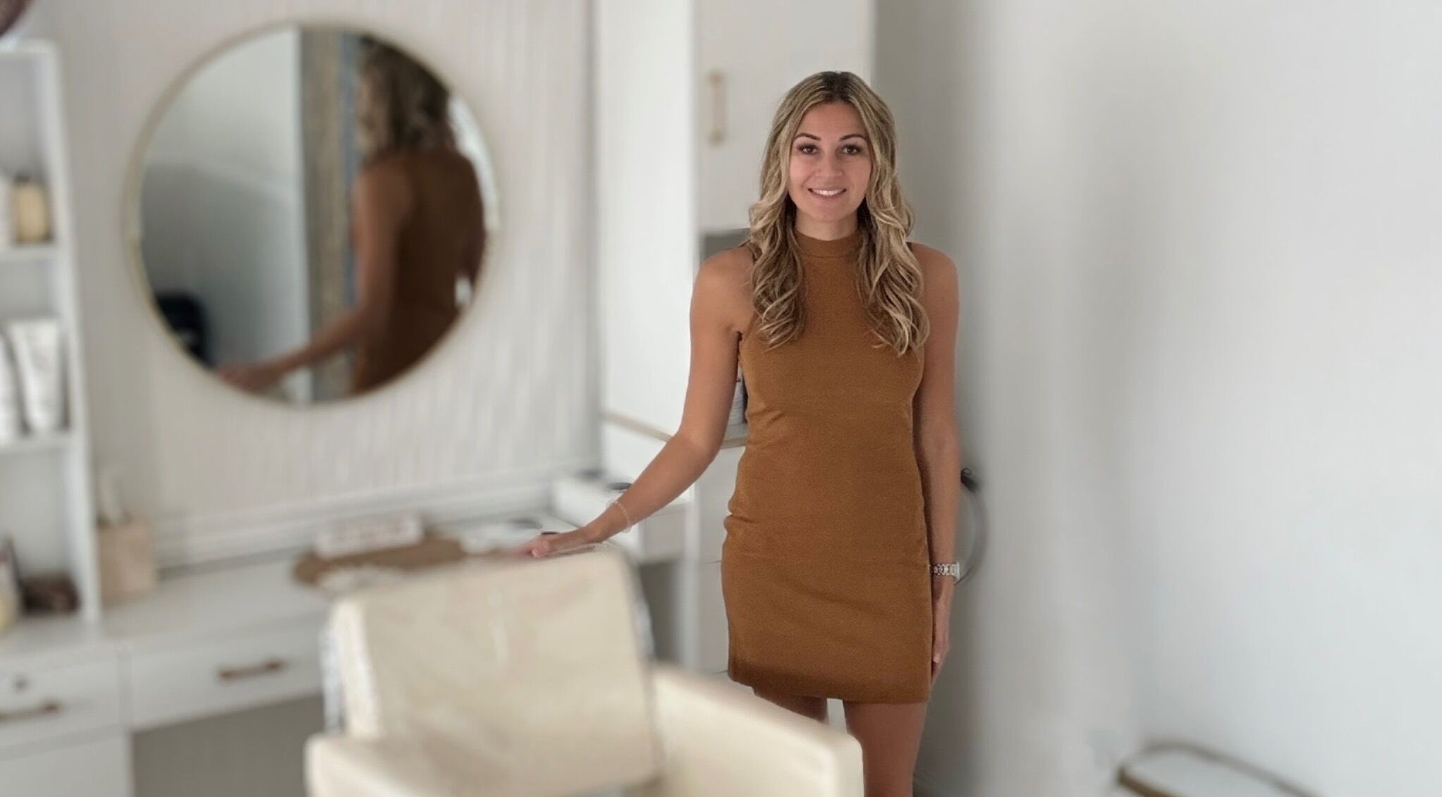 Woman smiling in chic interior at Elevate Salon Llc, Alpena, Michigan, US.