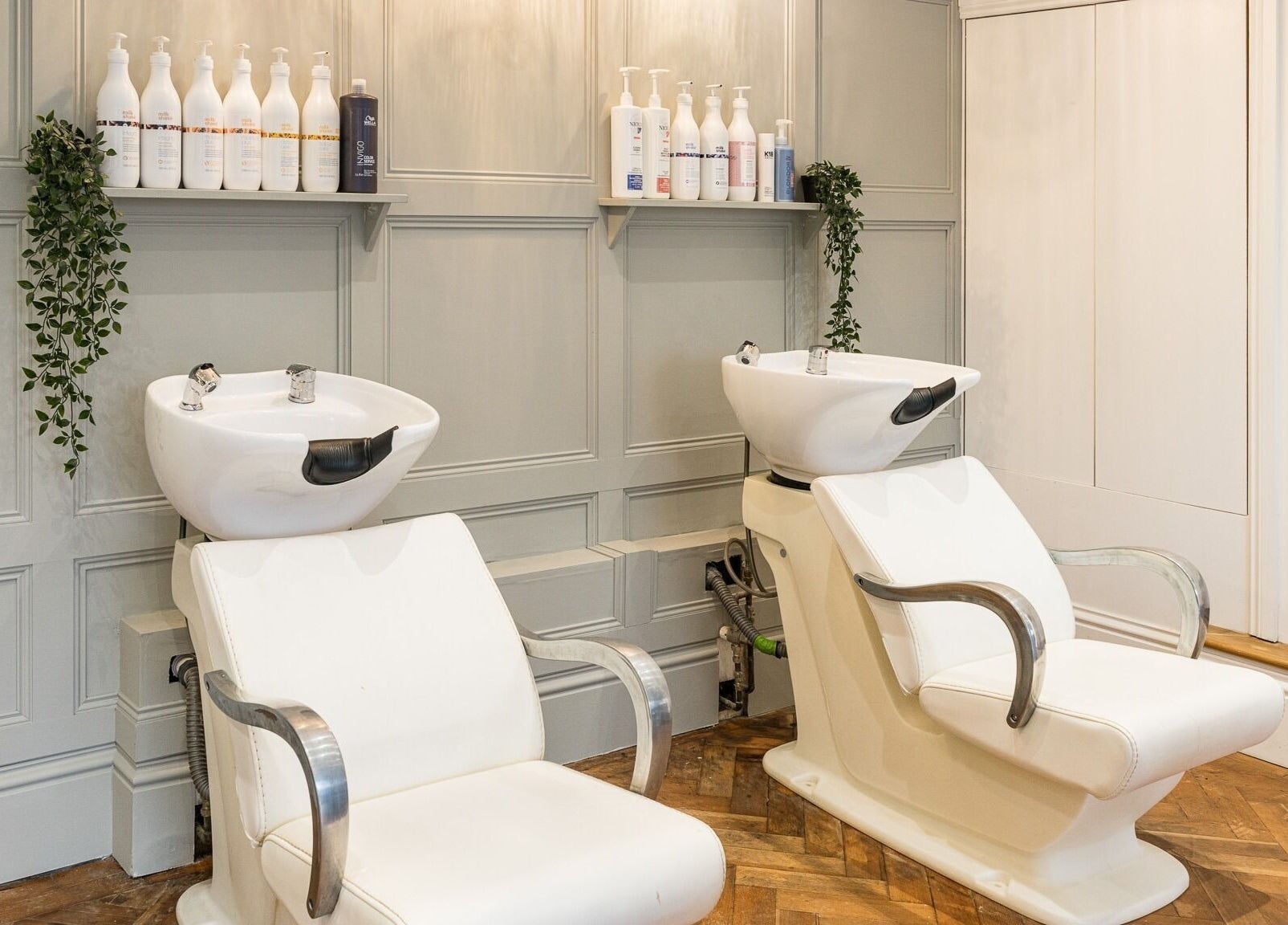 Modern wash stations at No 53 Salon, Walton on the Hill, England, GB, featuring elegant design and plush seating.