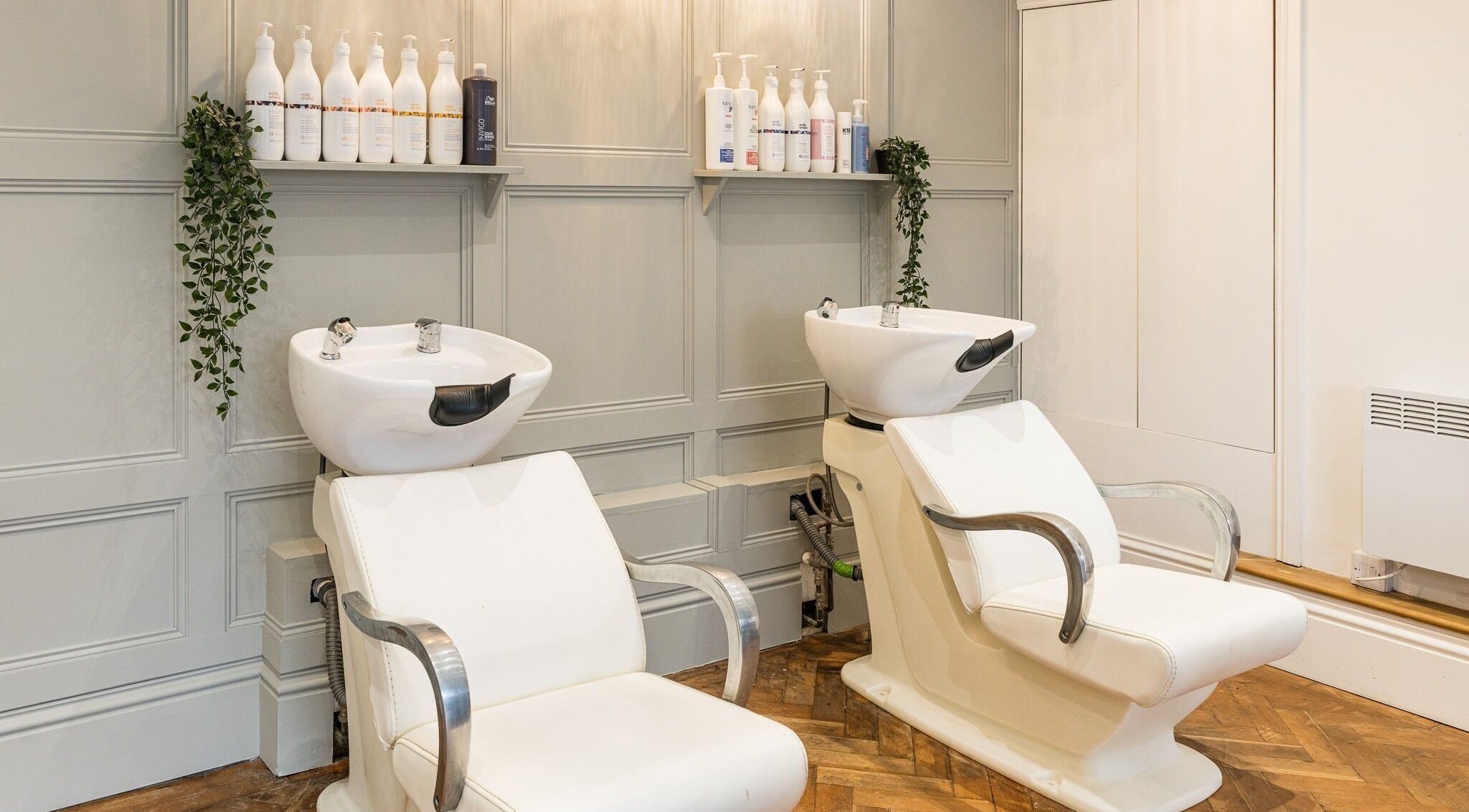 Modern wash stations at No 53 Salon, Walton on the Hill, England, GB, featuring elegant design and plush seating.