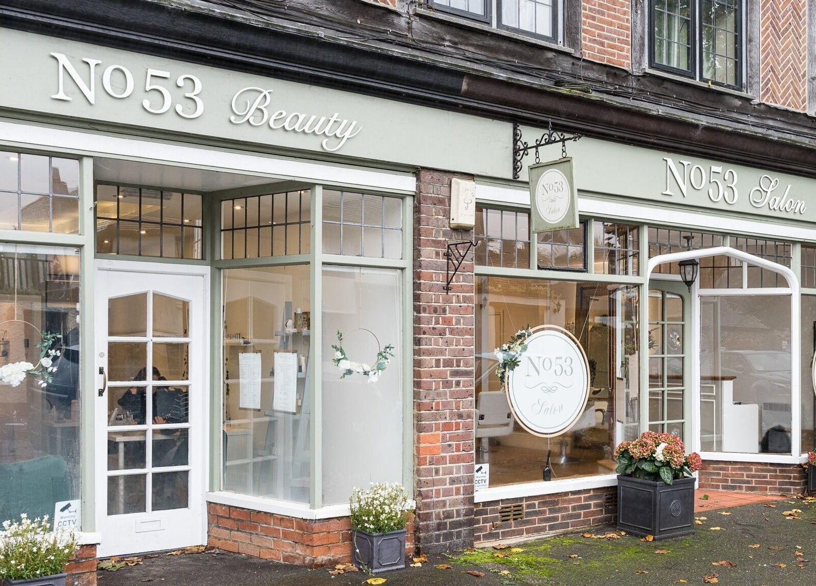 Exterior of No 53 Salon in Walton on the Hill, England, GB, featuring elegant signage and floral decor.