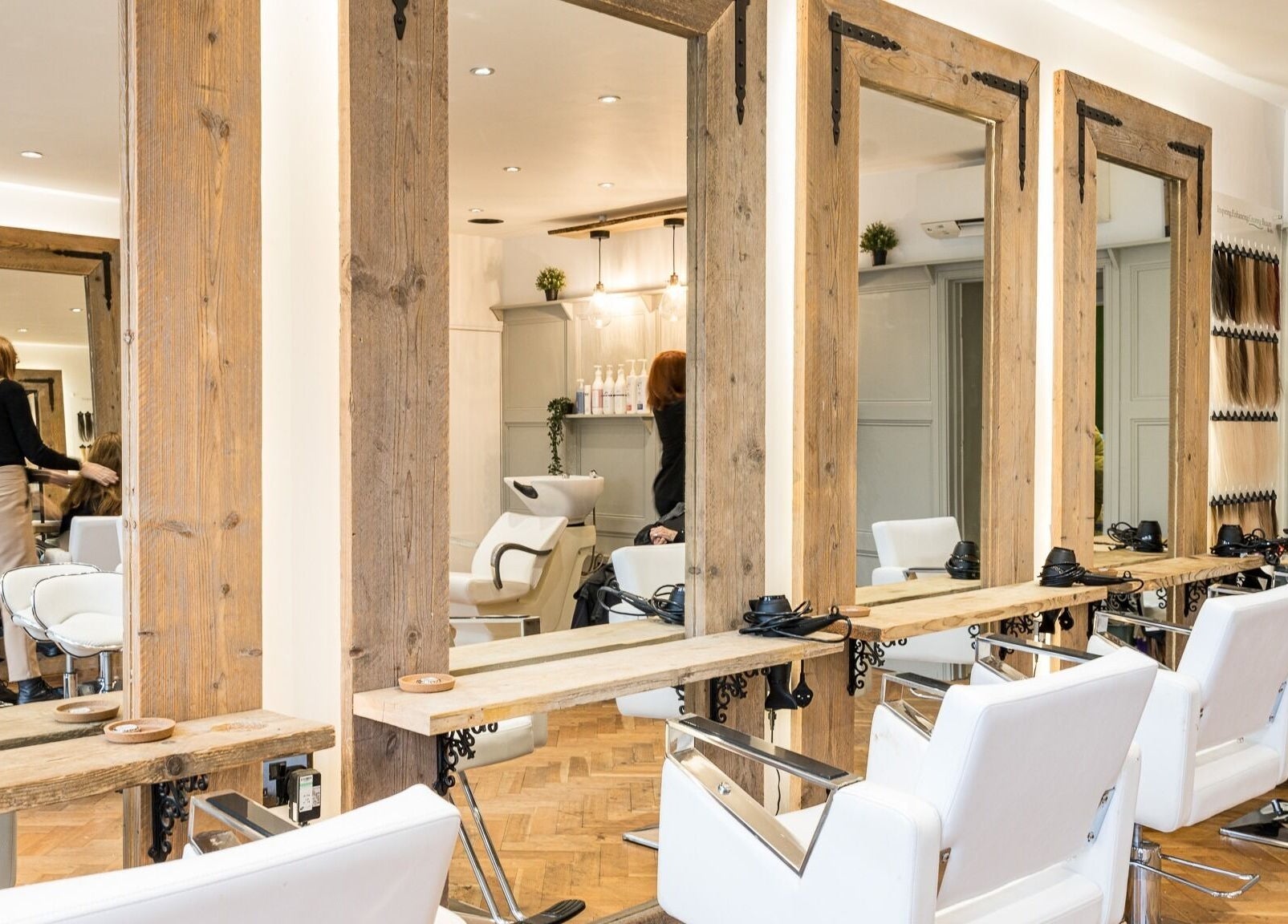 Interior of No 53 Salon in Walton on the Hill, England, GB, showcasing elegant styling stations and chairs.