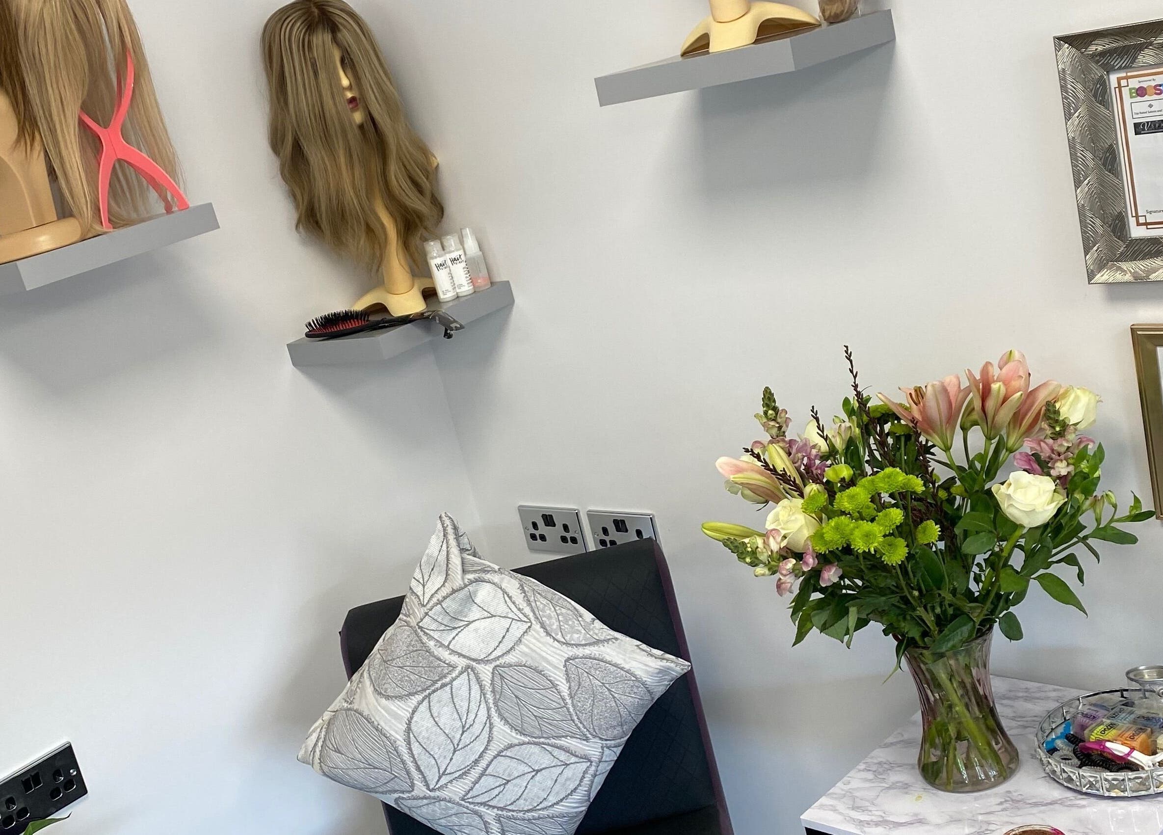 Sophisticated salon decor at Hair Extensions by Rebecca Banham in Spilsby, England, GB with awards and flowers.