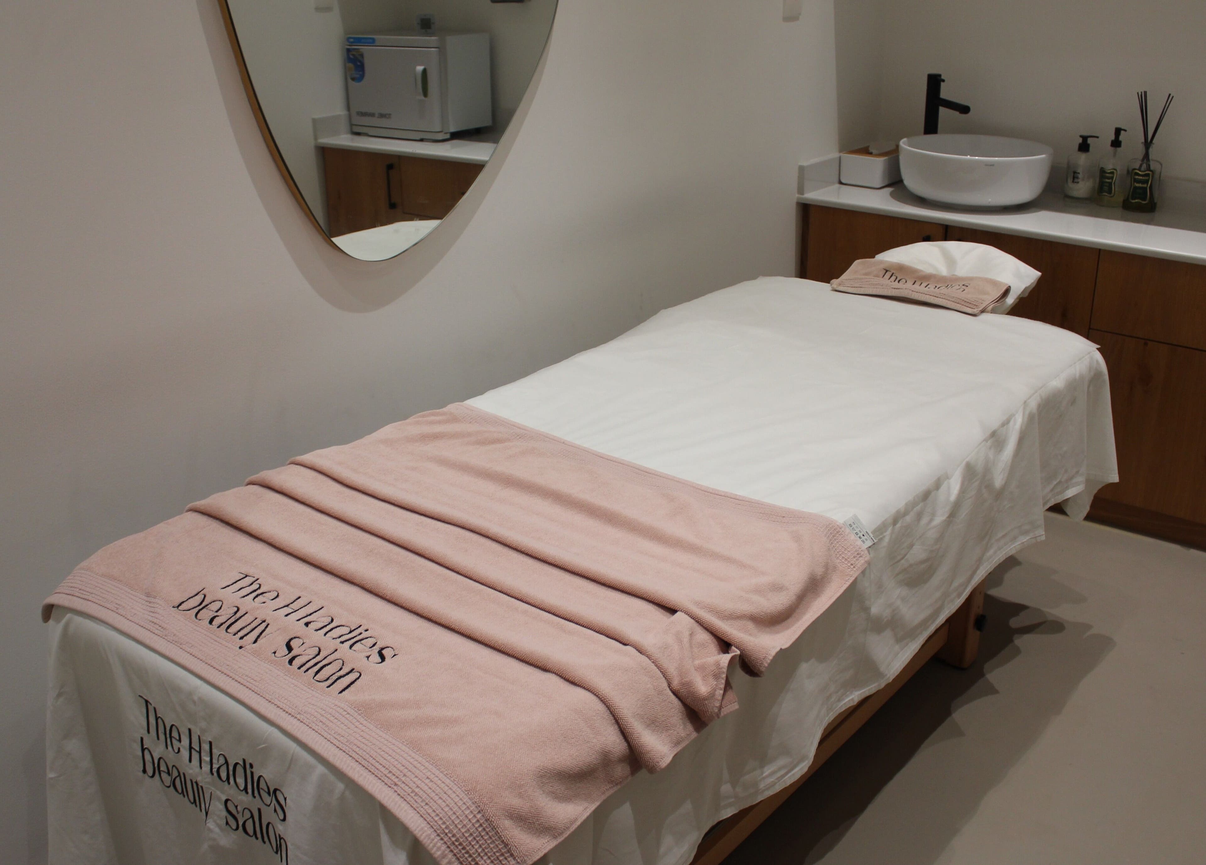 Cozy treatment room at The H Ladies Beauty Salon - L.L.C - O.P.C, Abu Dhabi, Abu Dhabi, AE with a massage bed.