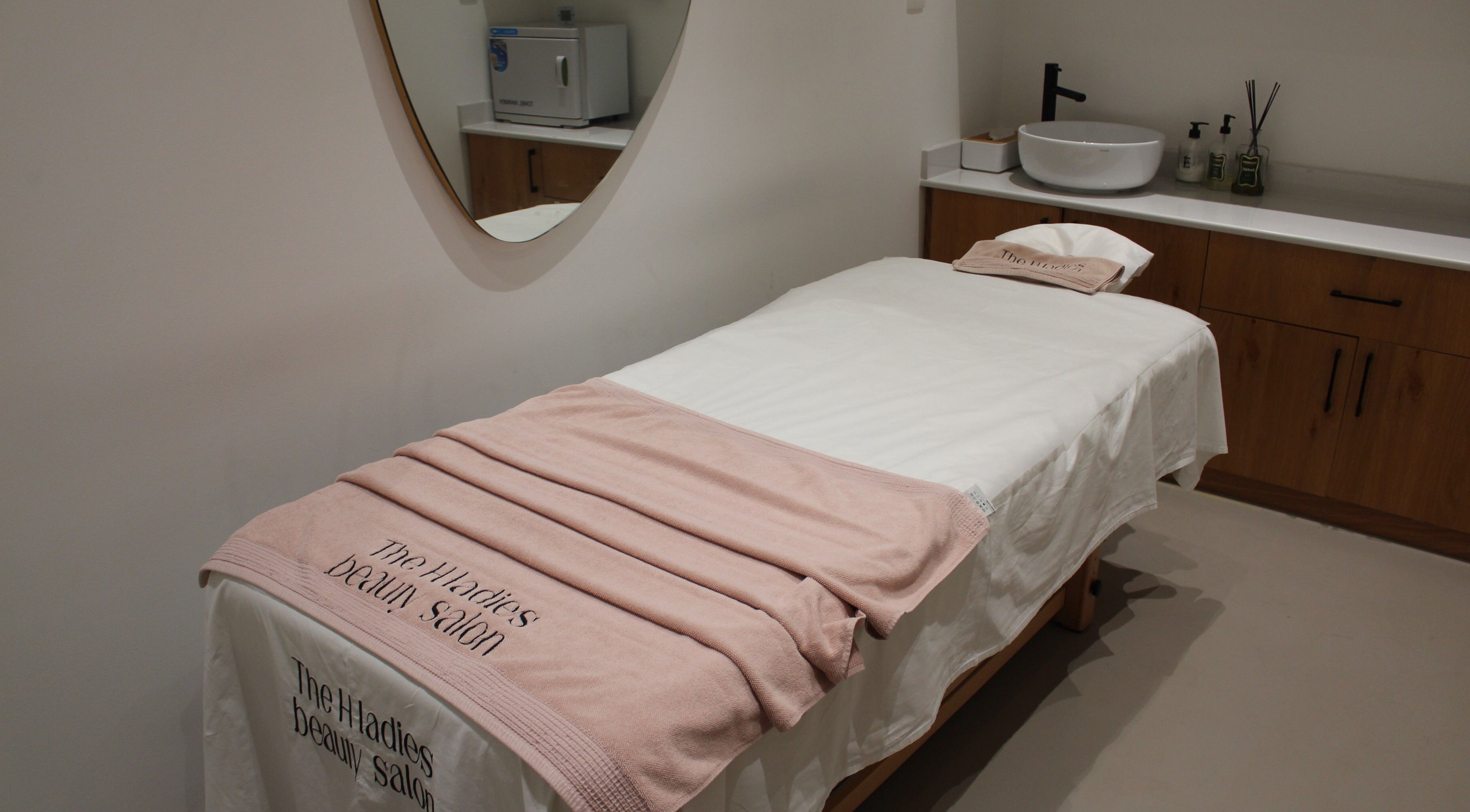 Cozy treatment room at The H Ladies Beauty Salon - L.L.C - O.P.C, Abu Dhabi, Abu Dhabi, AE with a massage bed.