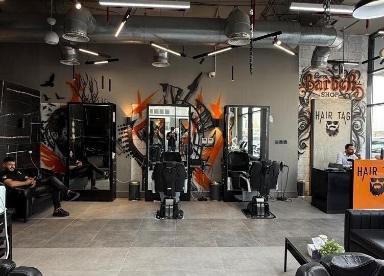 Modern interior of Hair Tag - Al Jaddaf, Dubai, AE with chic barber chairs and graffiti art.
