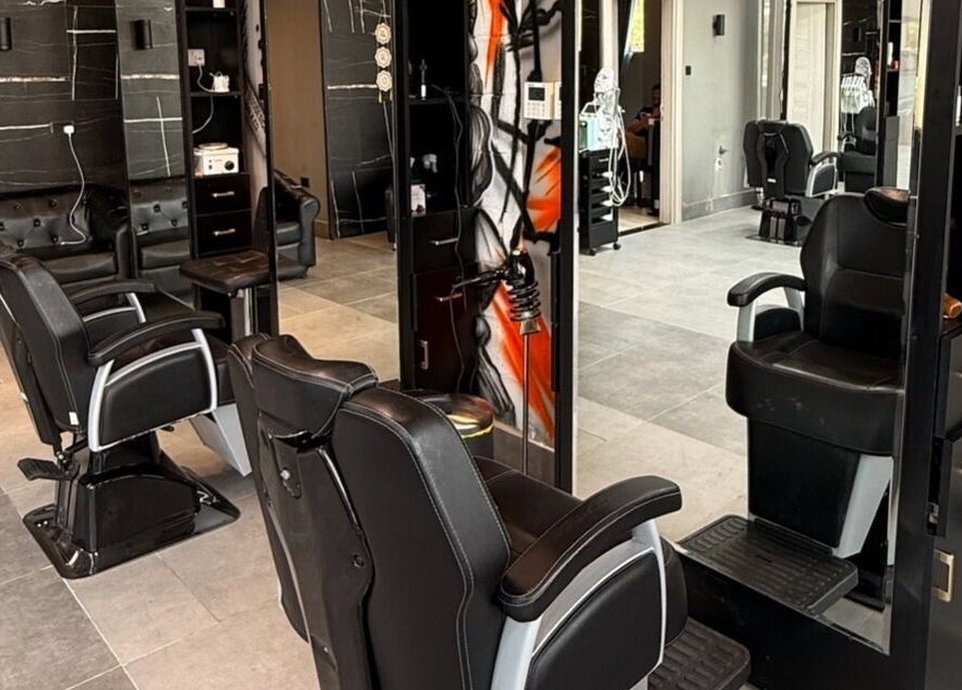 Modern salon interior at Hair Tag - Al Jaddaf, Dubai, AE with stylish black chairs and decor.